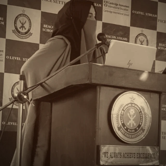 Javaria Yousuf Ali speaking at a podium